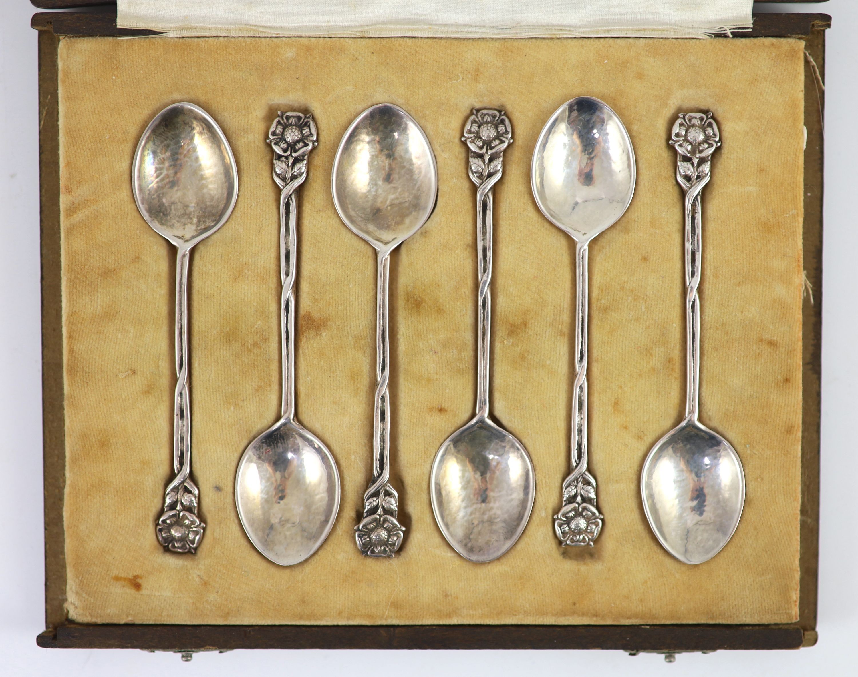 A cased set of six George V Arts & Crafts silver teaspoons, by Omar Ramsden